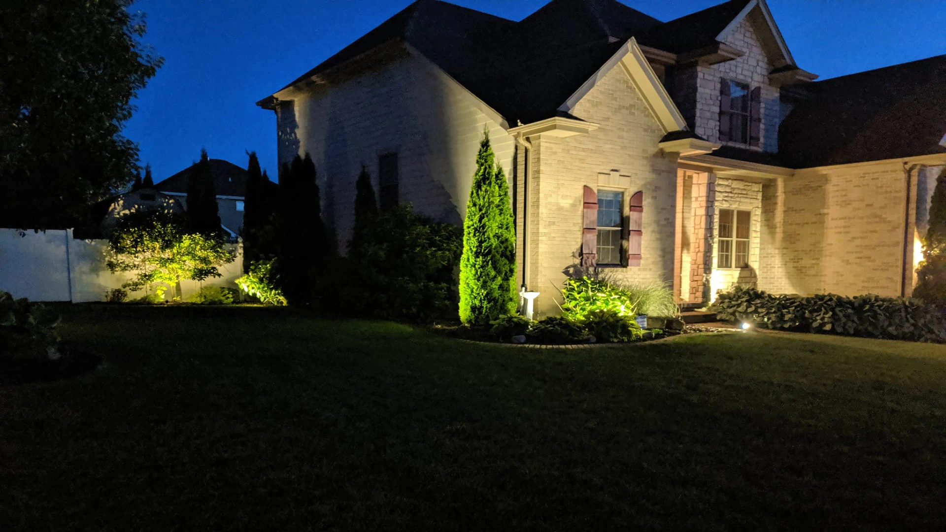 beige house with sark roofing and trees around