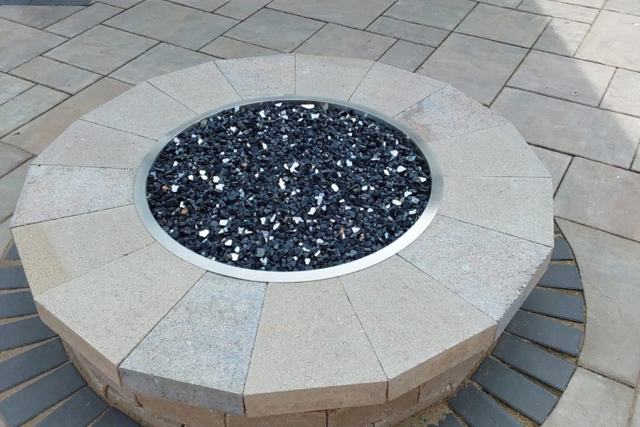 grey fire pit with grey paving brickers
